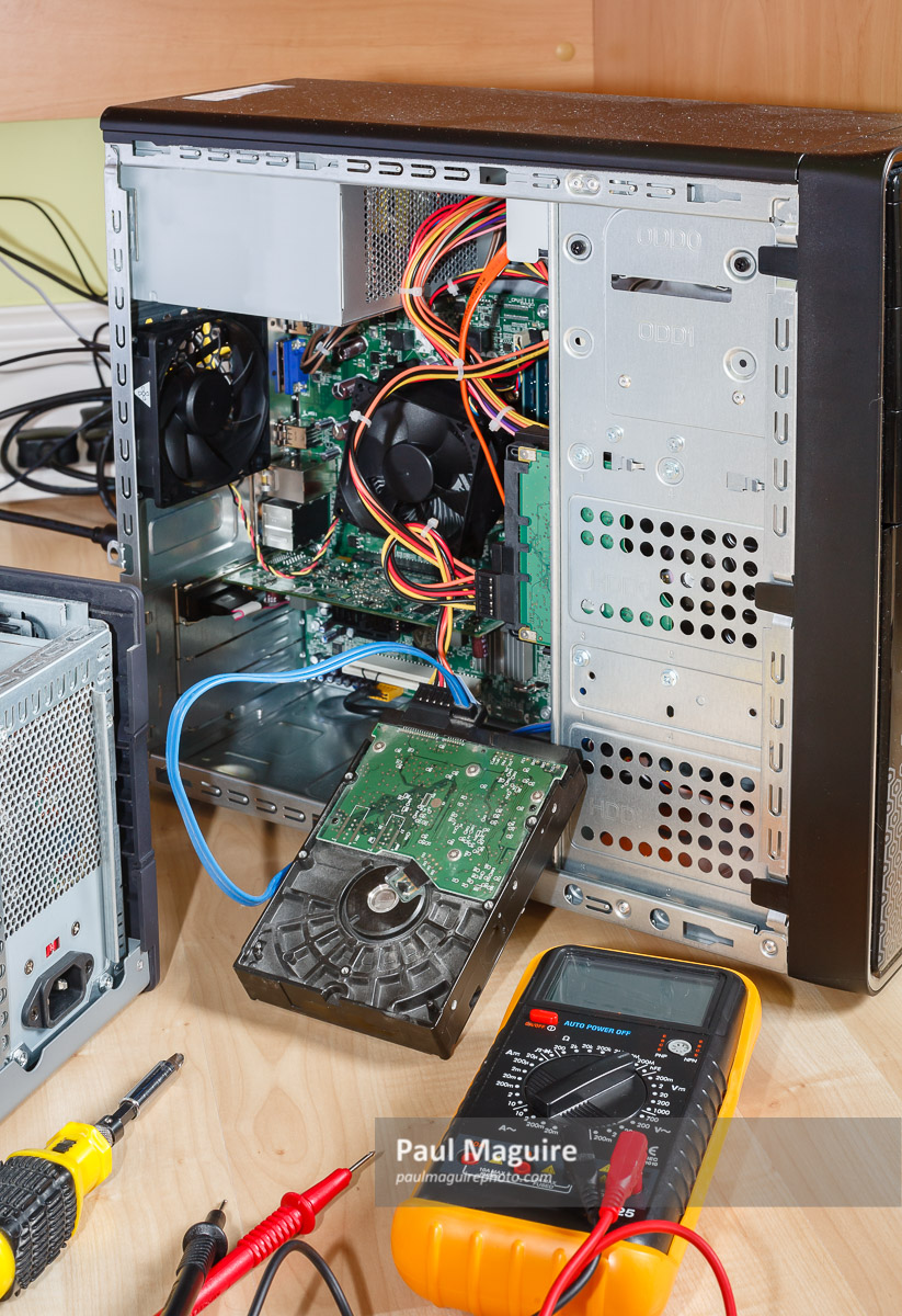 Stock photo Computer repair. Open tower PC upgrading hard drive UK