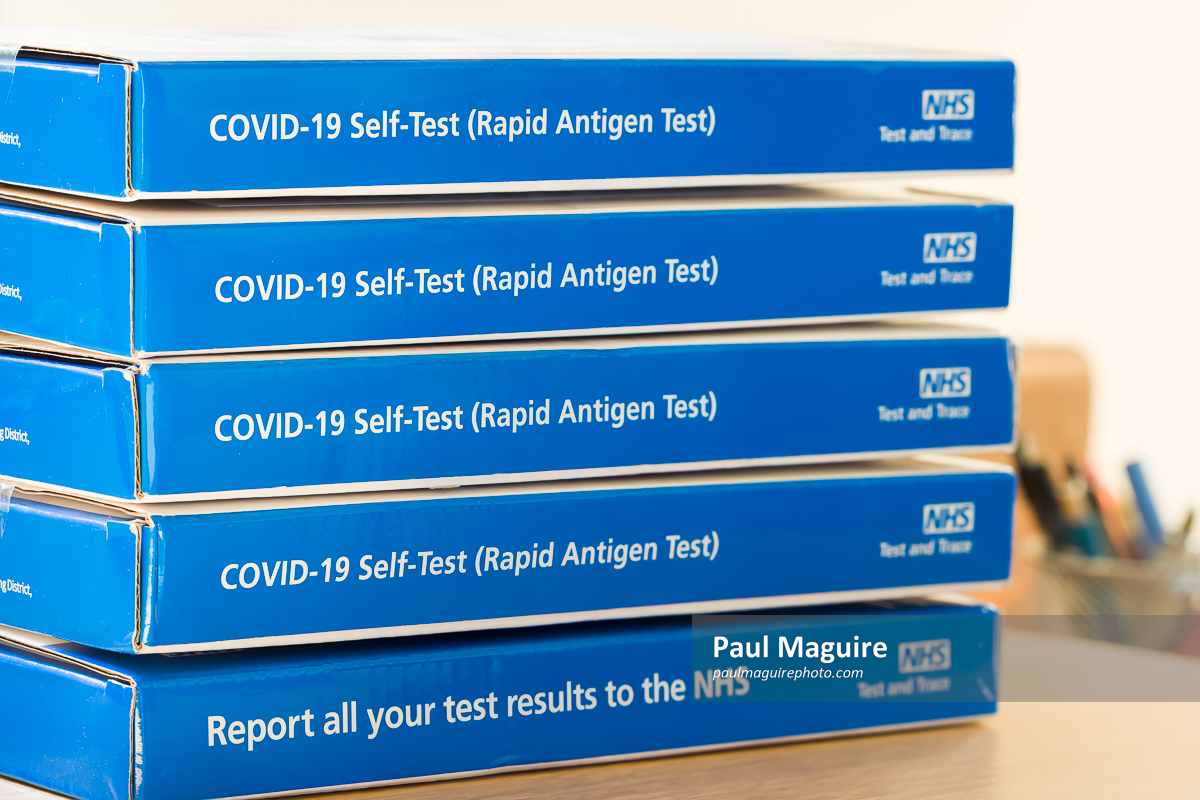 Stock photo Stack of Covid LFT testing kits, boxes, NHS trace and