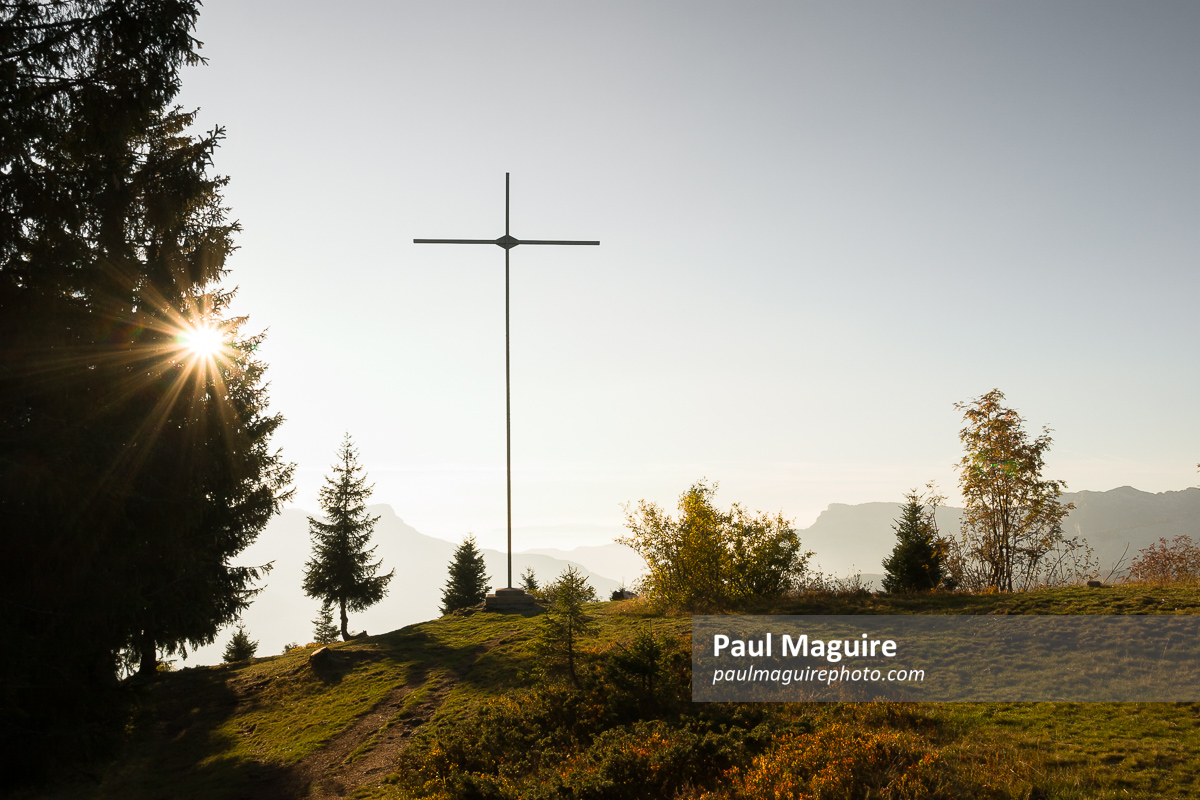 Cross on a mountain peak in French Alps. Aravis Mountains France