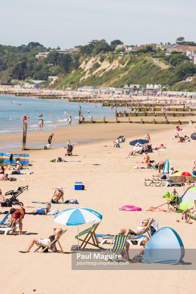 Sunbathers on sandy beach, Bournemouth, Dorset, UK