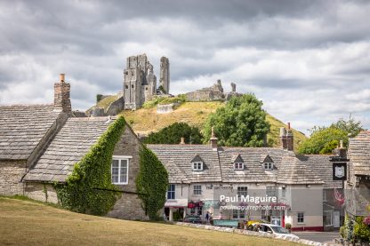 Historic village with Corfe Castle ruins in background Dorset UK