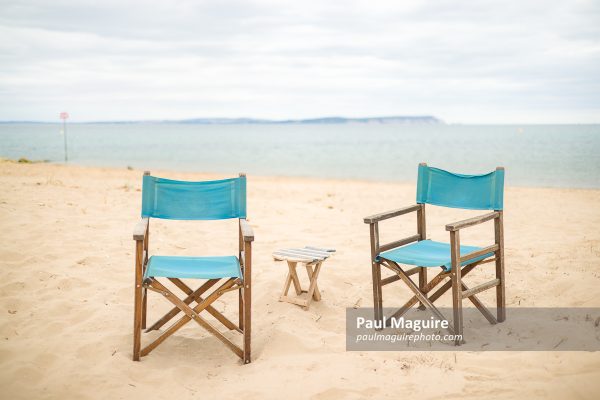 Chairs on a beach. Dorset coast with view of Isle of Wight, UK