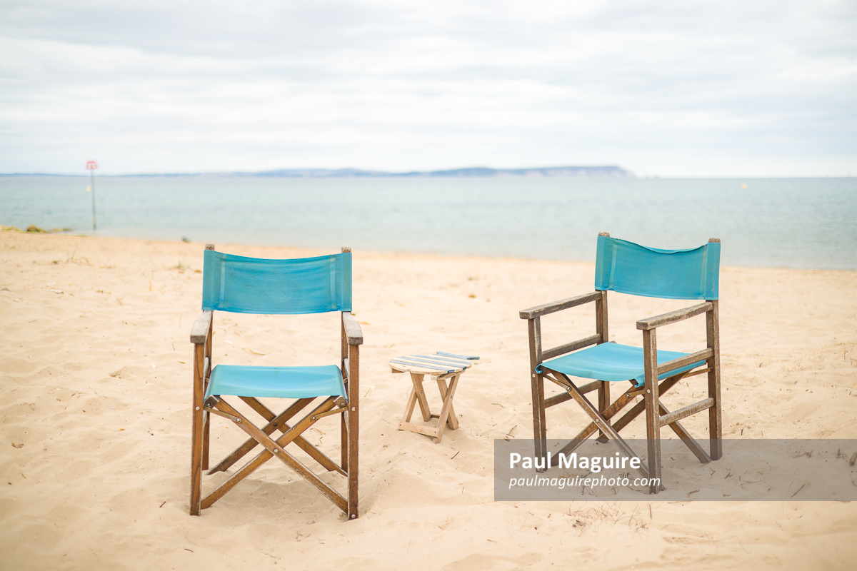 Chairs on a beach. Dorset coast with view of Isle of Wight, UK