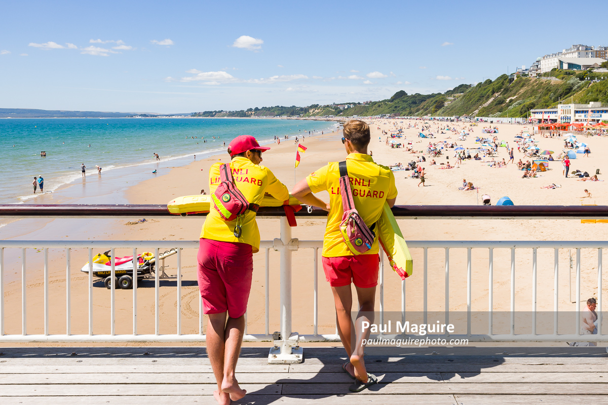Lifeguards watching Bournemouth beach in summer, UK