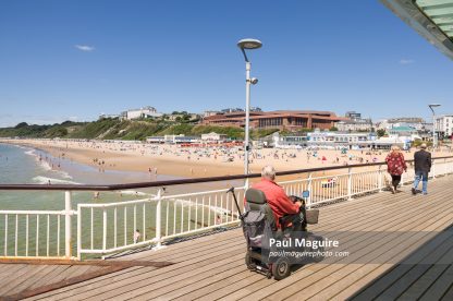 Old man on a mobility scooter at Bournemouth Pier, UK