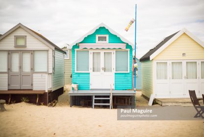 Beach huts on sandy beach, Hengistbury Head, Dorset, UK