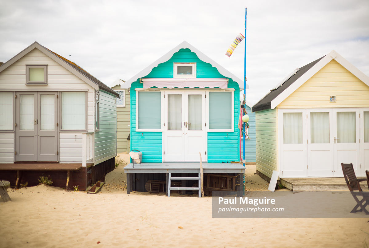 Beach huts on sandy beach, Hengistbury Head, Dorset, UK