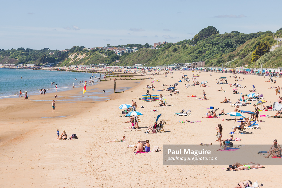 Sunbathers on sandy beach, Bournemouth, Dorset, UK