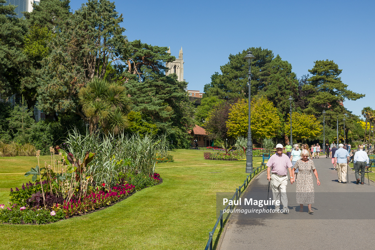Old people, elderly couple walking in park, Bournemouth, UK