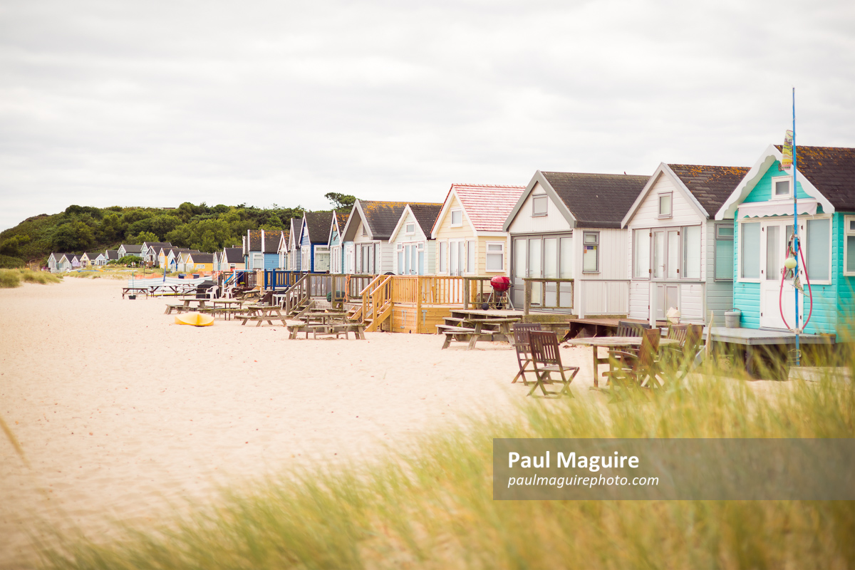 Beach huts on sandy beach, Hengistbury Head, Dorset, UK