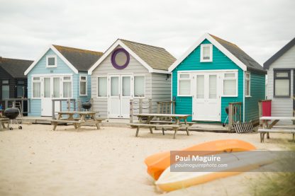 Wooden beach huts on seaside in summer. Dorset, UK