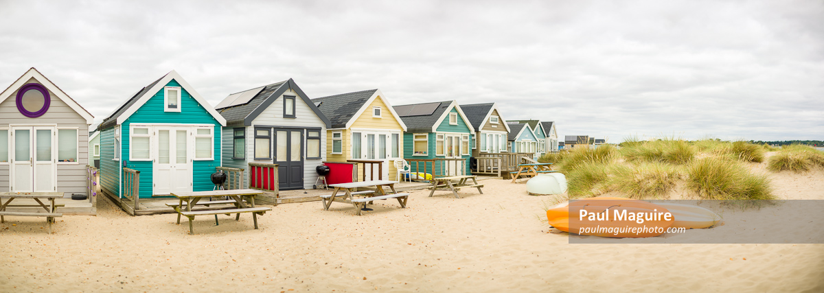 Beach huts on sandy beach, Hengistbury Head, Dorset, UK