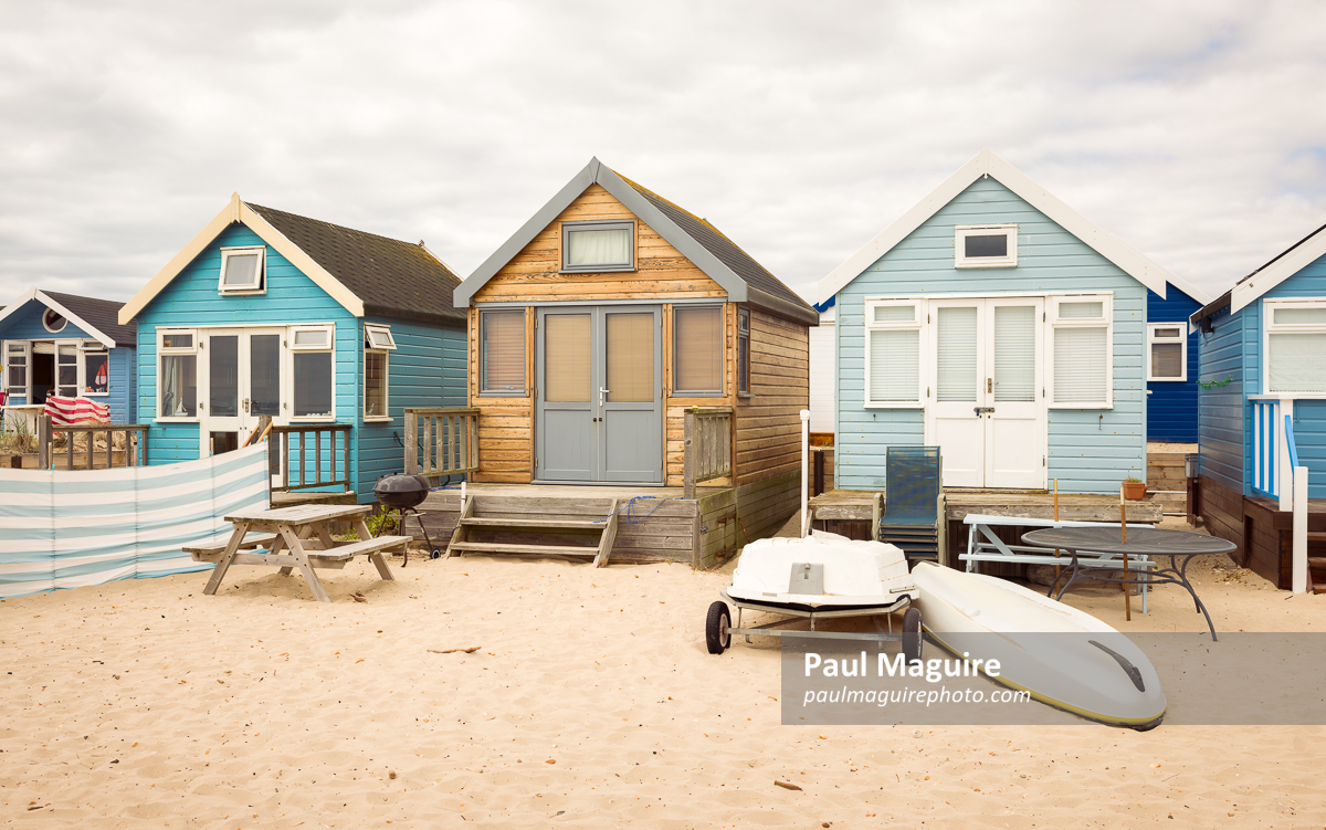 Beach houses on sandy beach, Hengistbury Head, Dorset, UK