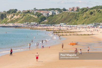 Man jogging on Bournemouth beach in summer, Dorset, UK