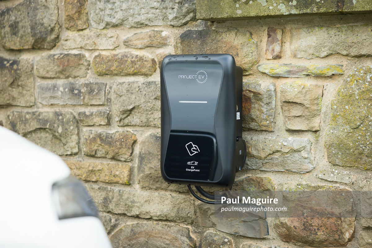 Electric car charging point on driveway at UK home